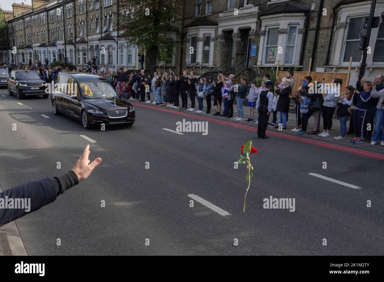 A person throws a flower towards Britain's Queen Elizabeth's coffin, as it is transported, on the day of her state funeral and burial, in London, Britain, September 19, 2022. REUTERS/Carlos Barria     TPX IMAGES OF THE DAY Stock Photo