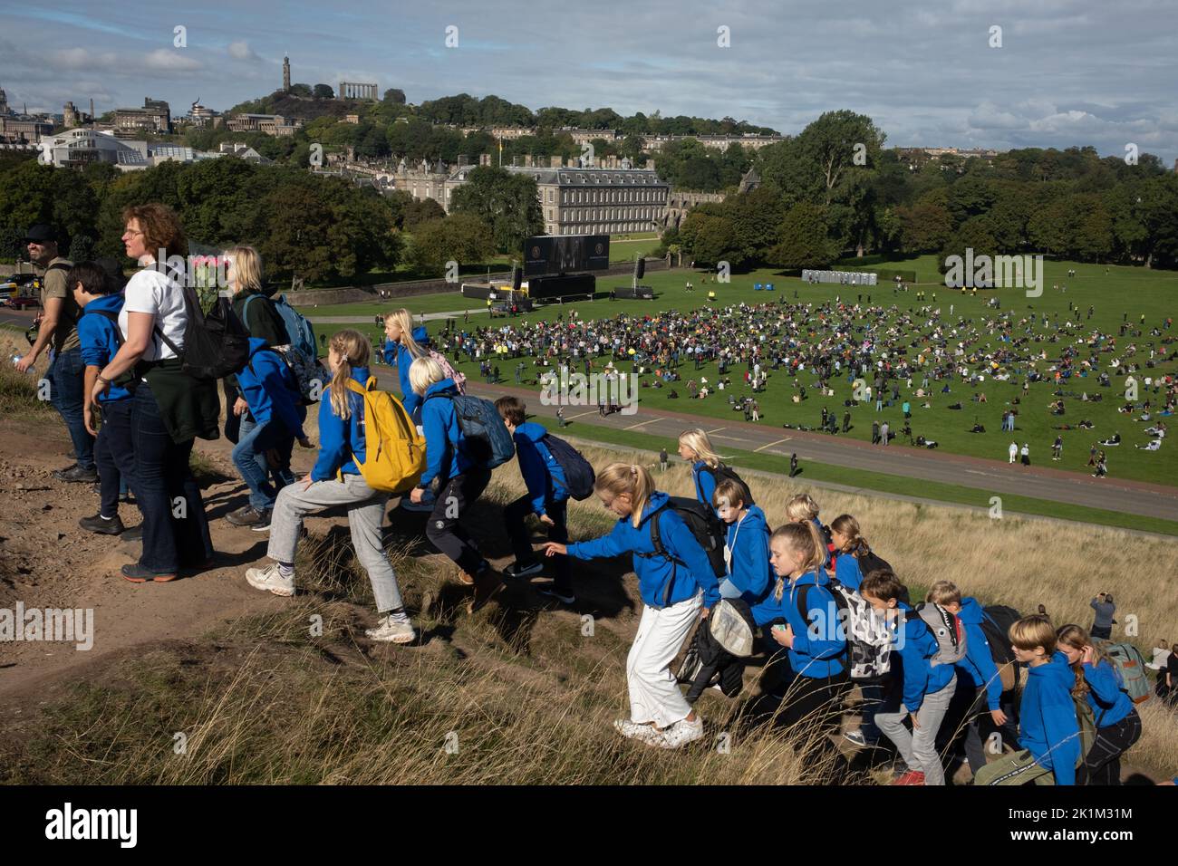 Edinburgh Scotland, 19 September 2022. In Holyrood Park, in front of the Royal family’s Palace of Holyroodhouse, crowds watch on a large screen the funeral in London of Her Majesty Queen Elizabeth II who died on 8th September, in Edinburgh Scotland, 19 September 2022. Photo credit: Jeremy Sutton-Hibbert/Alamy Live News. Stock Photo