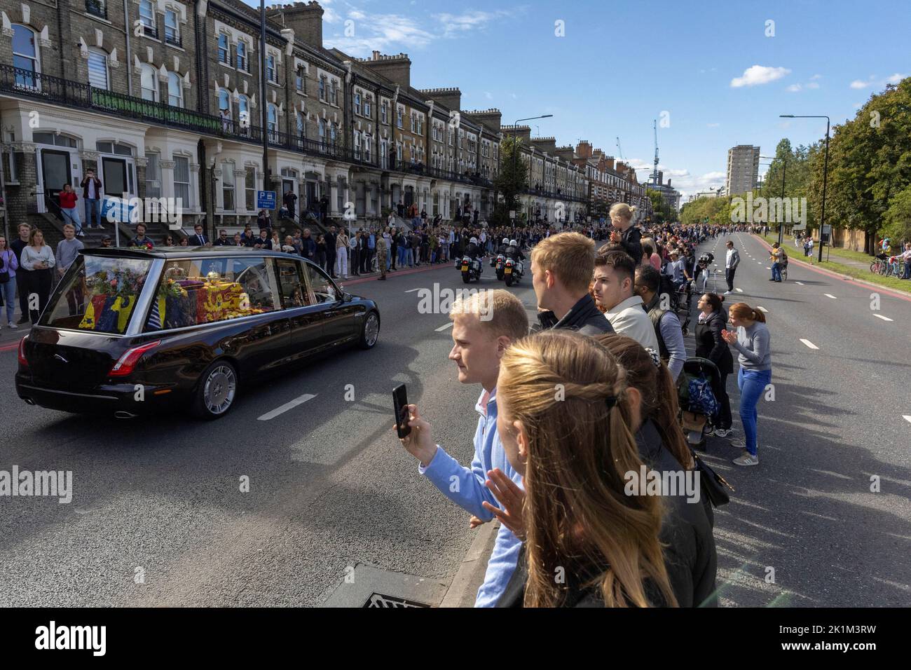 People watch as Britain's Queen Elizabeth's coffin is transported, on the day of her state funeral and burial, in London, Britain, September 19, 2022. REUTERS/Carlos Barria Stock Photo