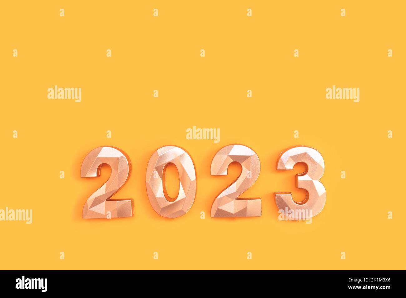 2023 golden numbers on a yellow background. New Year's minimal concept. Stock Photo