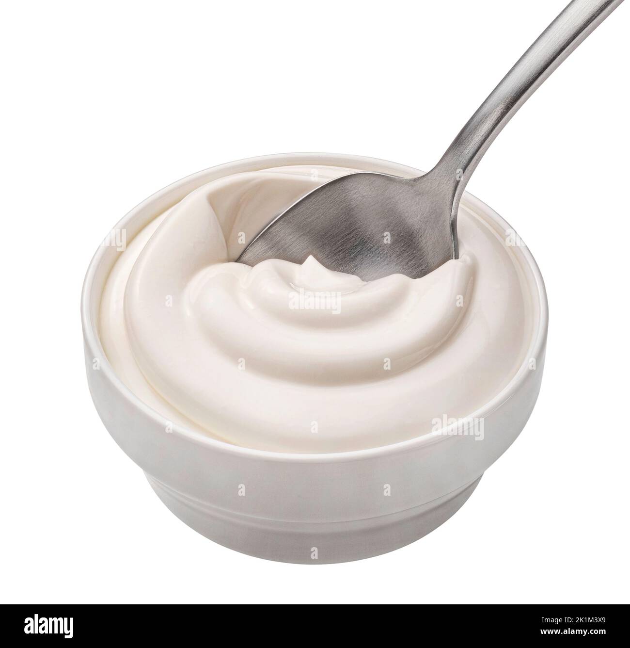 Bowl of sour cream in spoon isolated on white background, top view Stock Photo