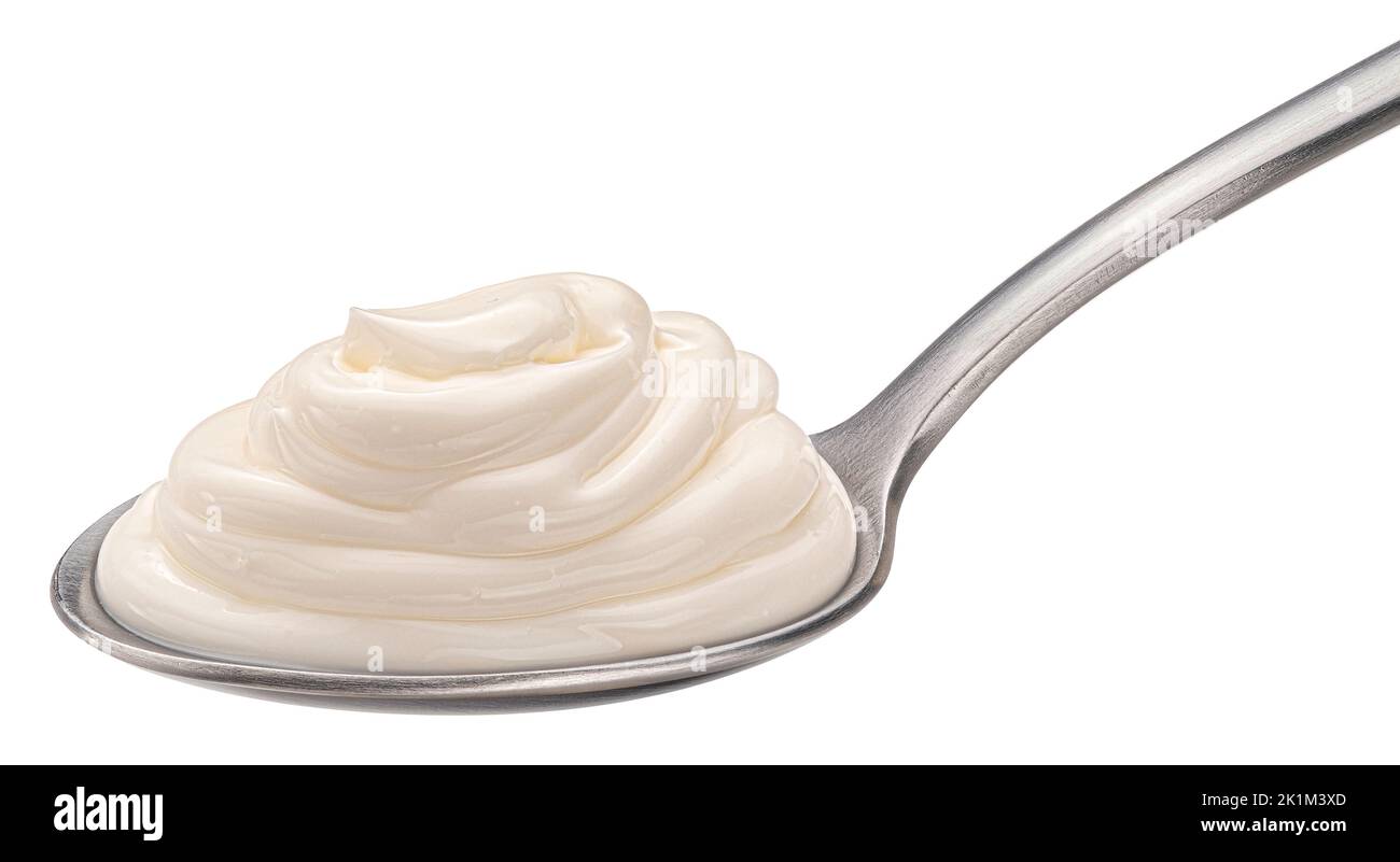Sour cream in spoon isolated on white background Stock Photo