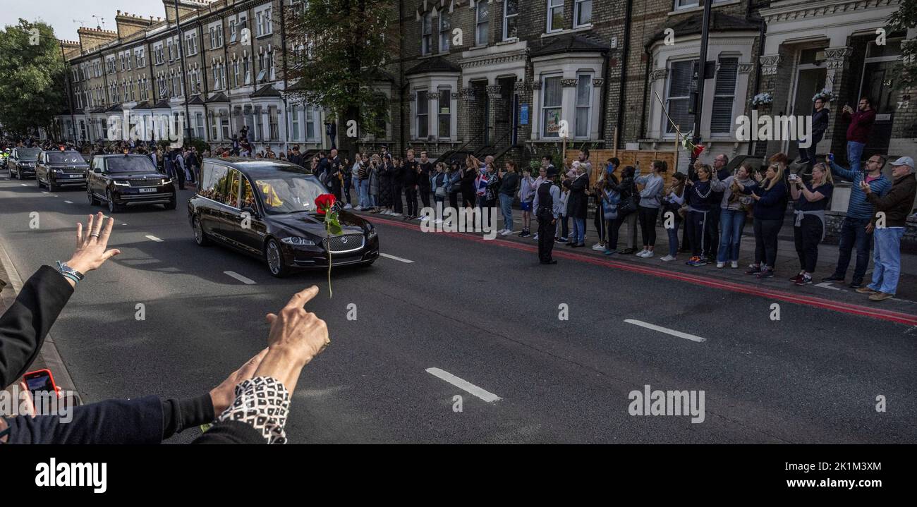 A person throws a flower towards Britain's Queen Elizabeth's coffin, as it is transported, on the day of her state funeral and burial, in London, Britain, September 19, 2022. REUTERS/Carlos Barria Stock Photo