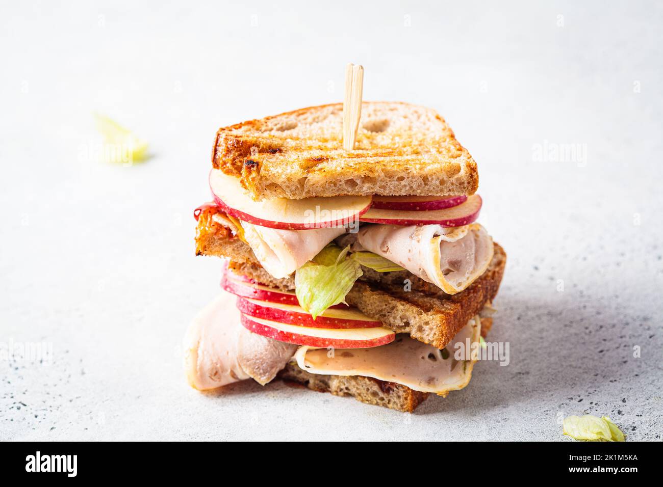 Turkey and apple sandwich, gray background, copy space. Thanksgiving leftovers concept. Stock Photo
