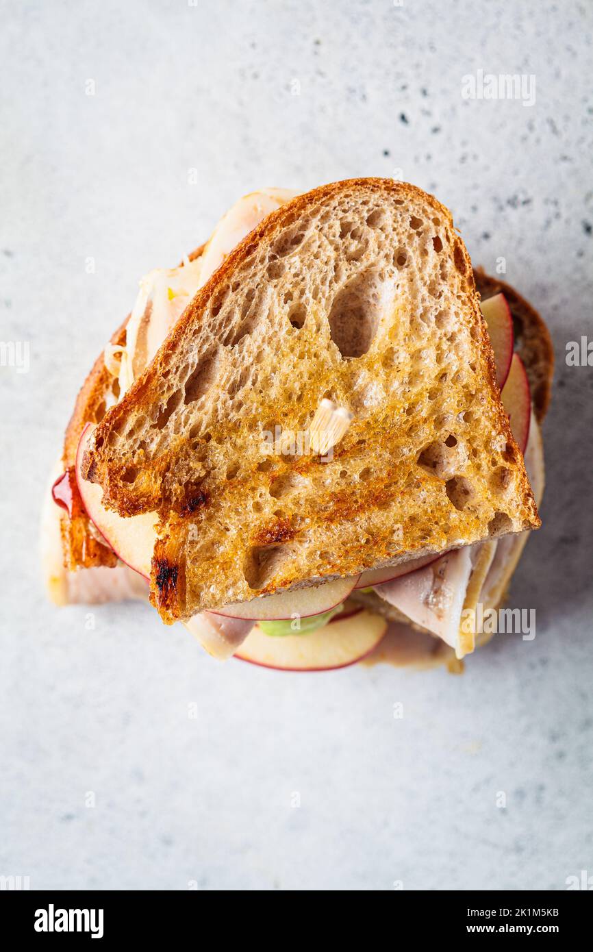 Turkey and apple sandwich, gray background, top view. Thanksgiving leftovers concept. Stock Photo