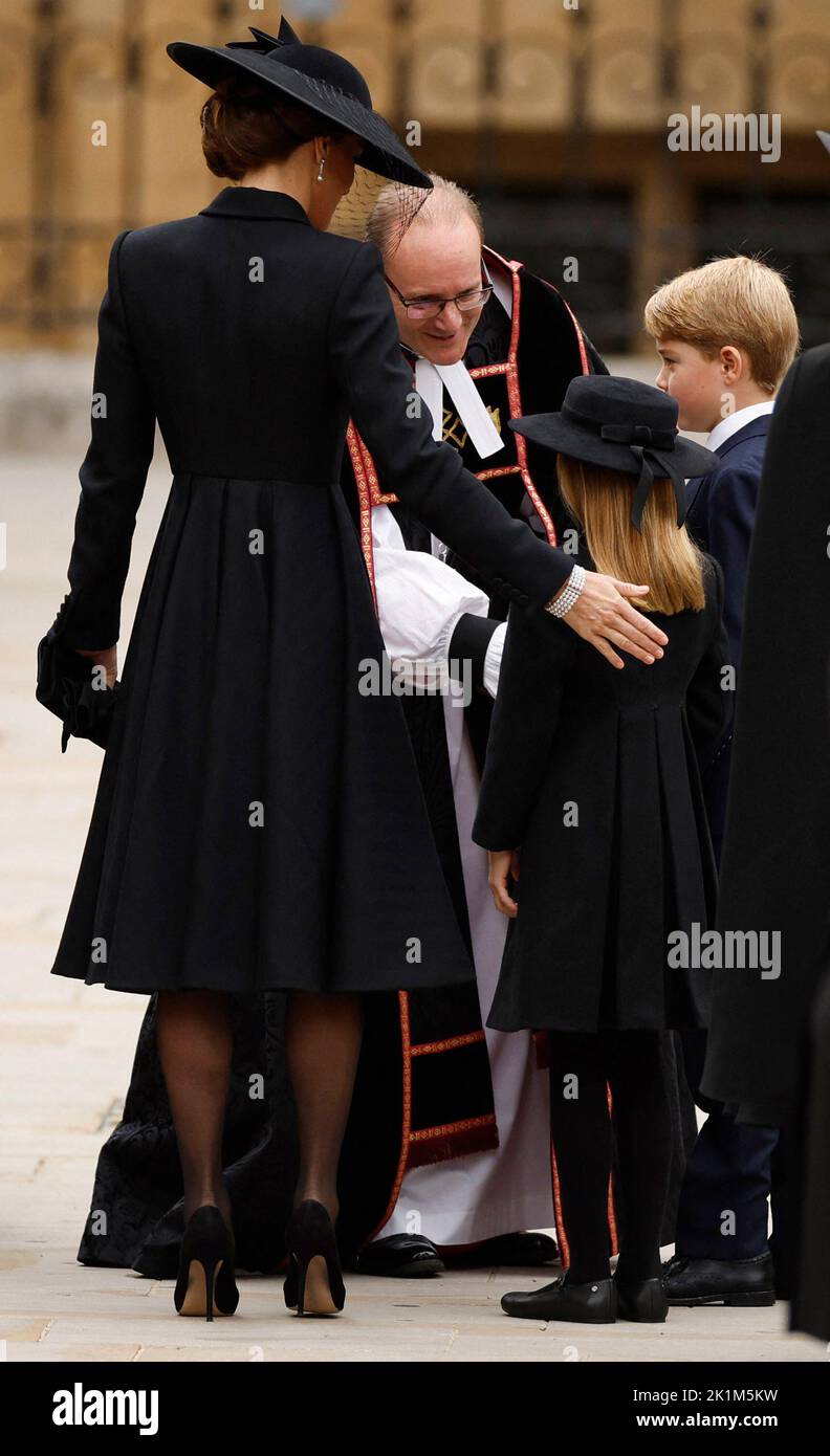Britain's Catherine, Princess of Wales, Britain's Princess Charlotte and Britain's Prince George are greeted by The Right Reverend Anthony Ball outside Westminster Abbey on the day of state funeral and burial of Britain's Queen Elizabeth, in London, Britain, September 19, 2022 REUTERS/John Sibley Stock Photo