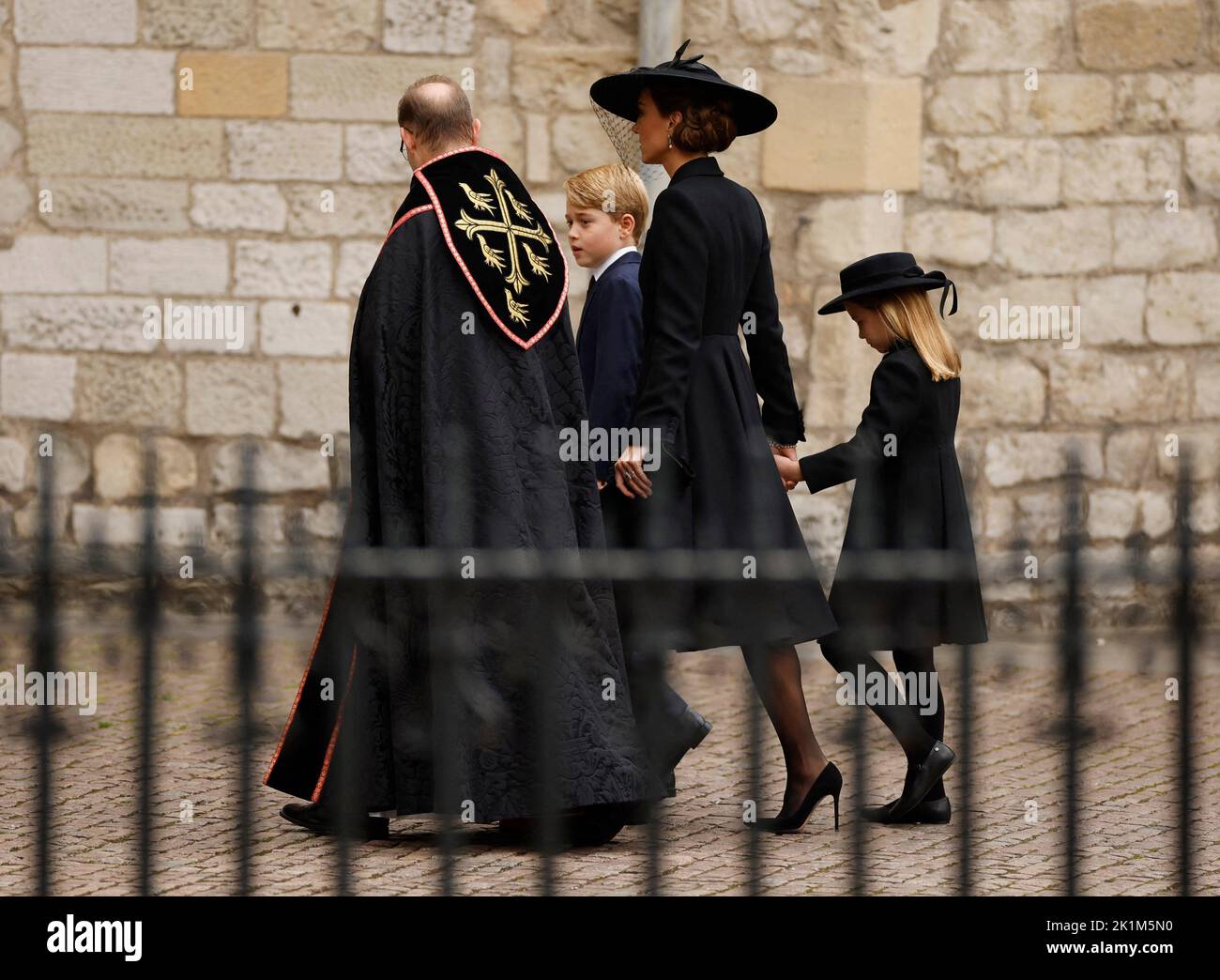 Britain's Catherine, Princess of Wales, Britain's Princess Charlotte and Britain's Prince George are greeted by The Right Reverend Anthony Ball outside Westminster Abbey on the day of state funeral and burial of Britain's Queen Elizabeth, in London, Britain, September 19, 2022 REUTERS/John Sibley Stock Photo