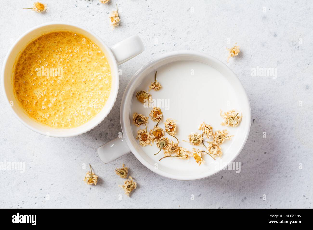 Chamomile moon milk and golden turmeric milk, top view. Ayurveda drink, healthy food, remedy for insomnia. Stock Photo