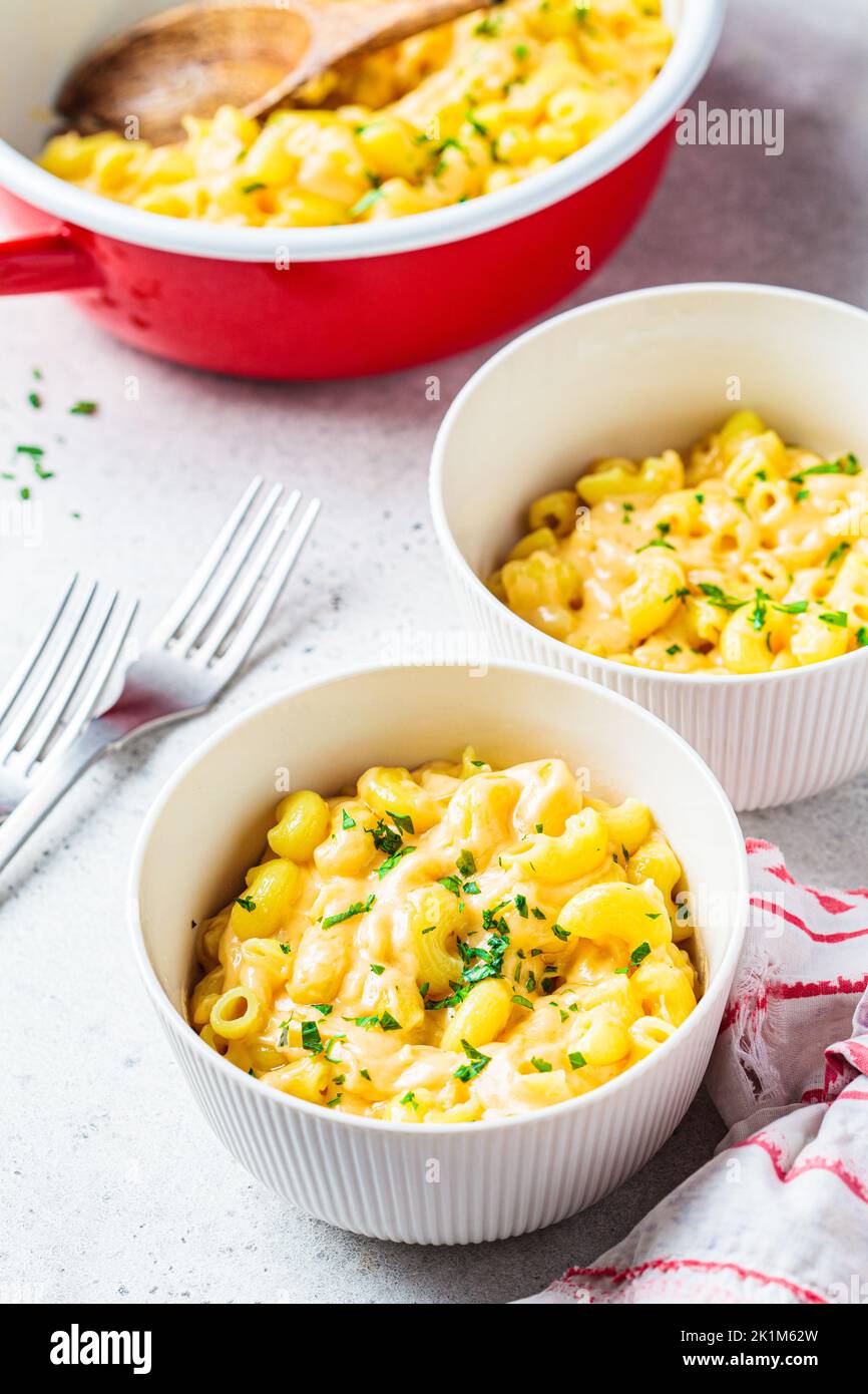 Mac and cheese in white bowl, close-up. Traditional American food. Stock Photo