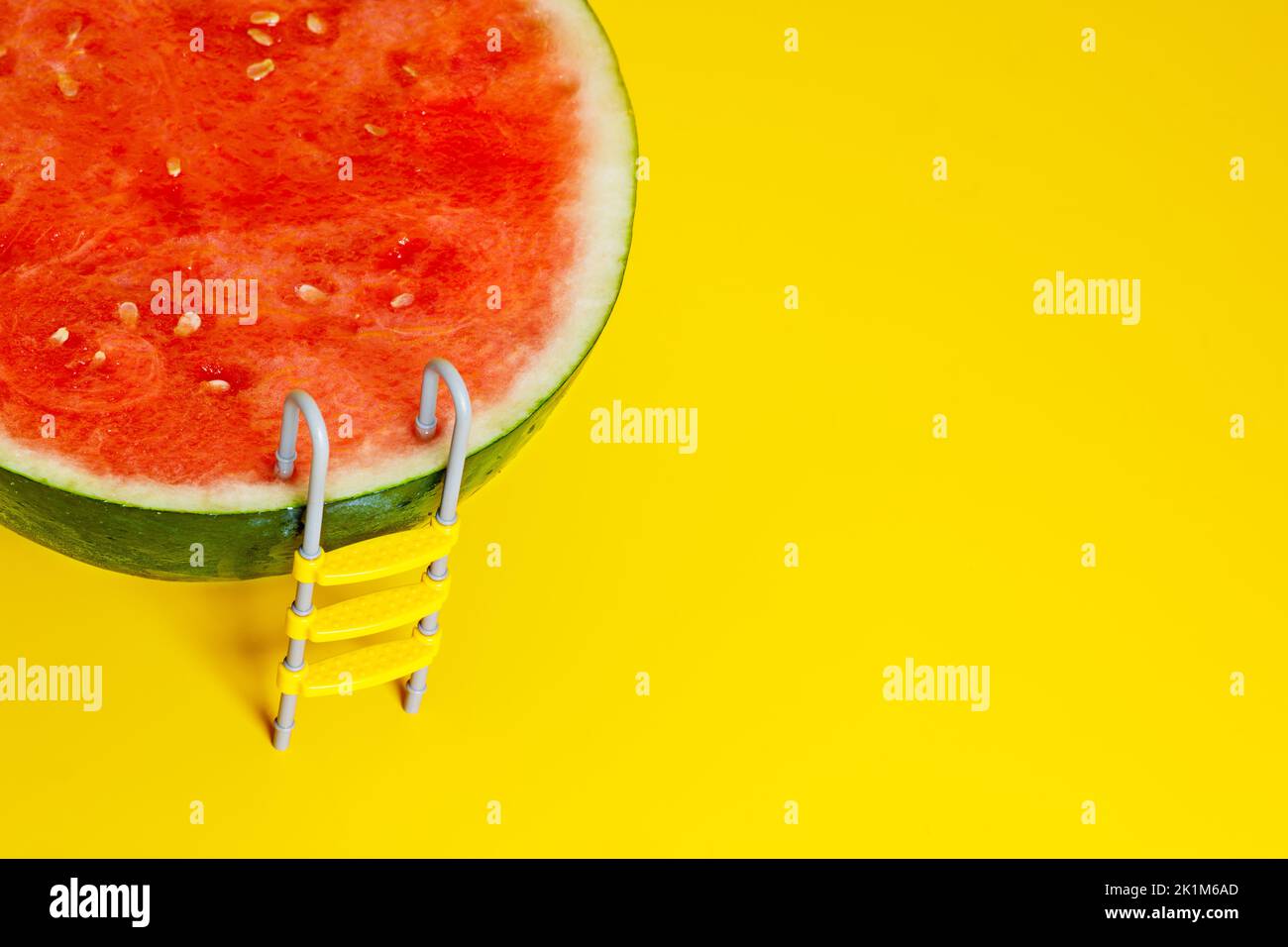 Juicy concept - watermelon fruit with pool ladder allegory Stock Photo