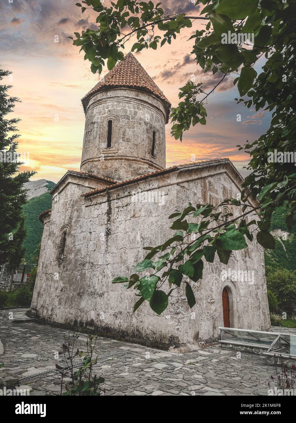 An old stone church with the sunset background Stock Photo - Alamy