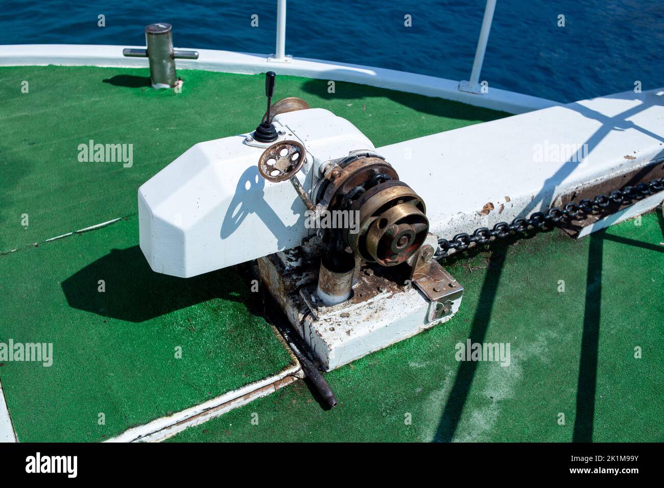 Anchor lifting mechanism engine on the boat. Anchor chain winch
