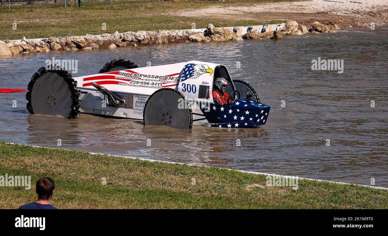 swamp buggy moving through water, action, in water, jeep style, vehicle sport, Florida Sports Park Naples, FL Stock Photo