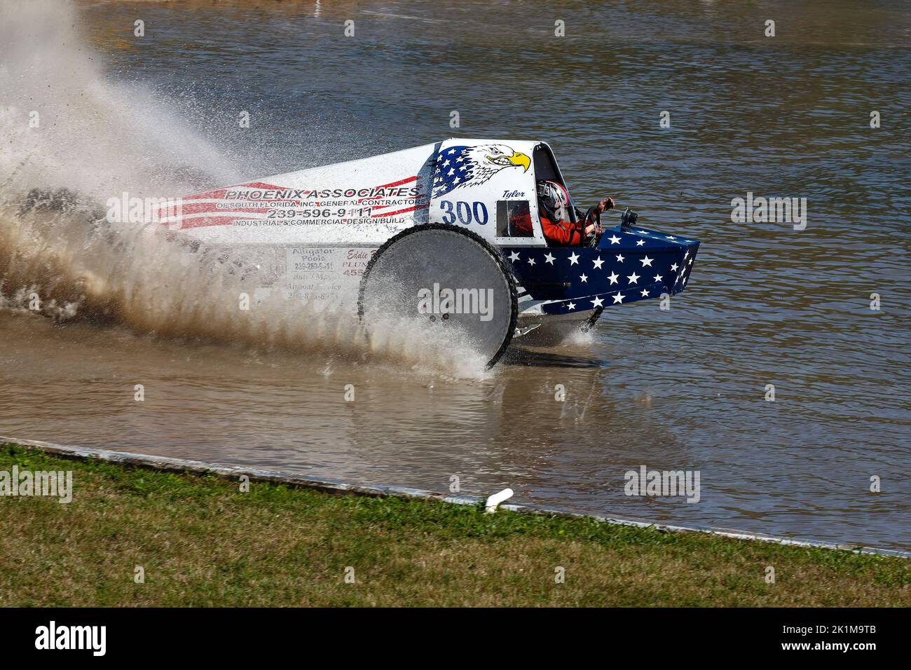 swamp buggy moving through water, action, close-up, water splashing, motion, jeep style, vehicle sport, patriotic, red, white, blue, Florida Sports Pa Stock Photo