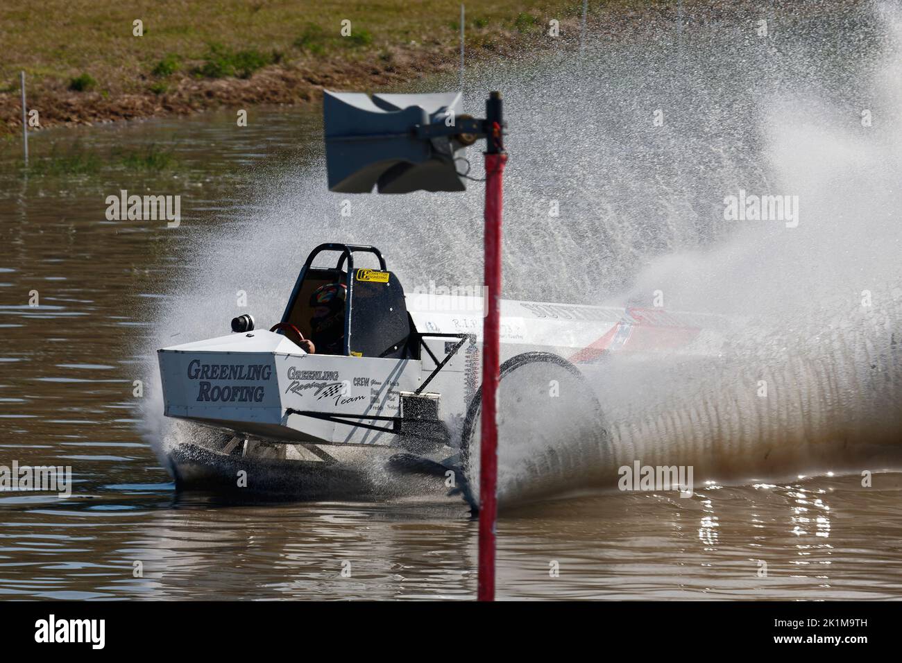 swamp buggy moving through water, action, close-up, large water spray, motion, jeep style, vehicle sport, Florida Sports Park, Naples, FL Stock Photo