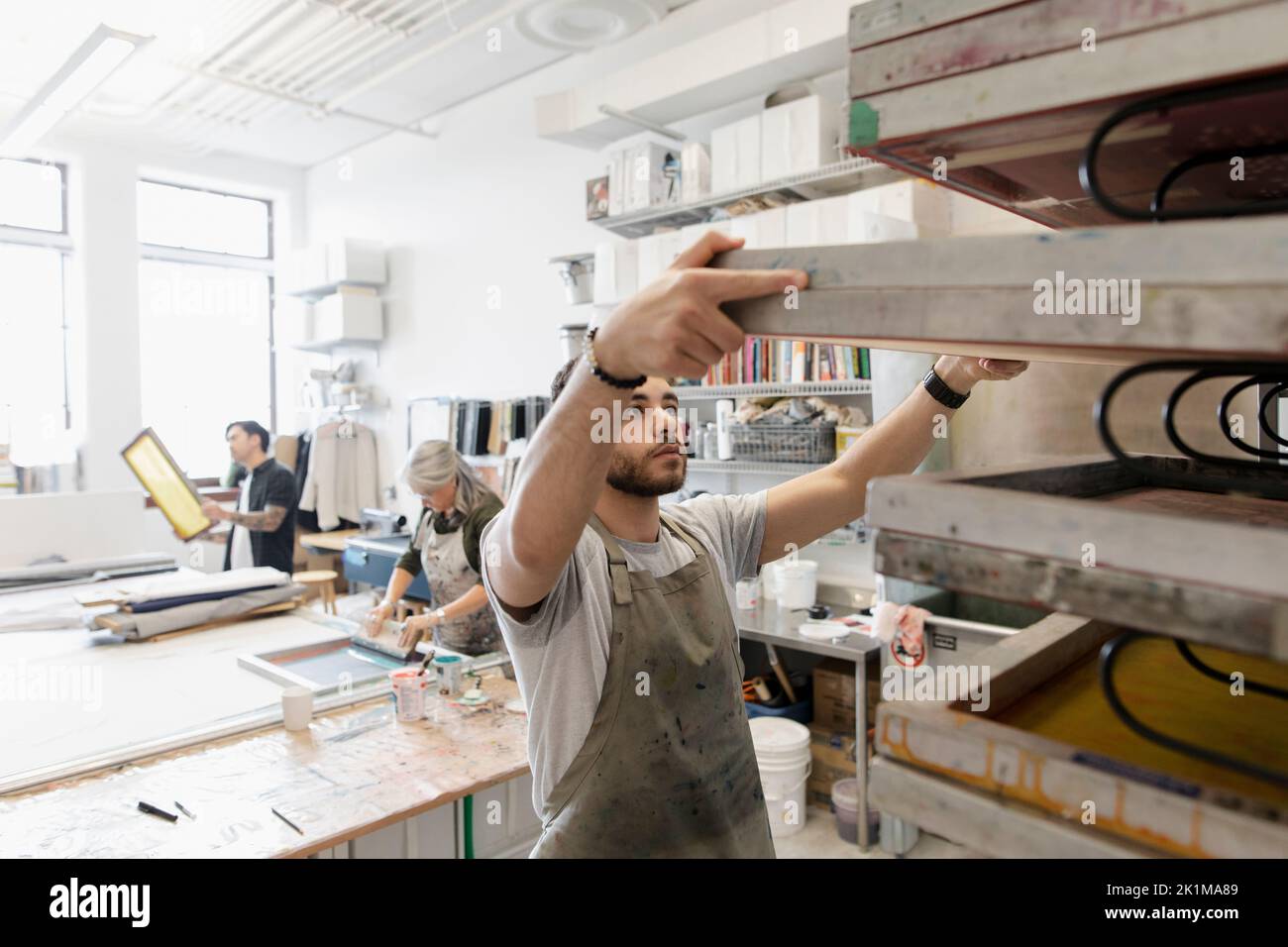 Young man removing screenprinting frame Stock Photo Alamy