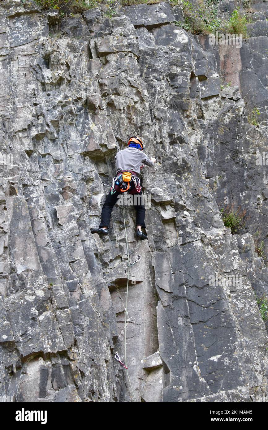 Cheddar, UK. 19th Sep, 2022. On a mild afternoon people climbing rockface of Cheddar Gorge with climbing safety ropes, helmet, shoes, and one climber with camera. Picture Credit: Robert Timoney/Alamy Live News Stock Photo