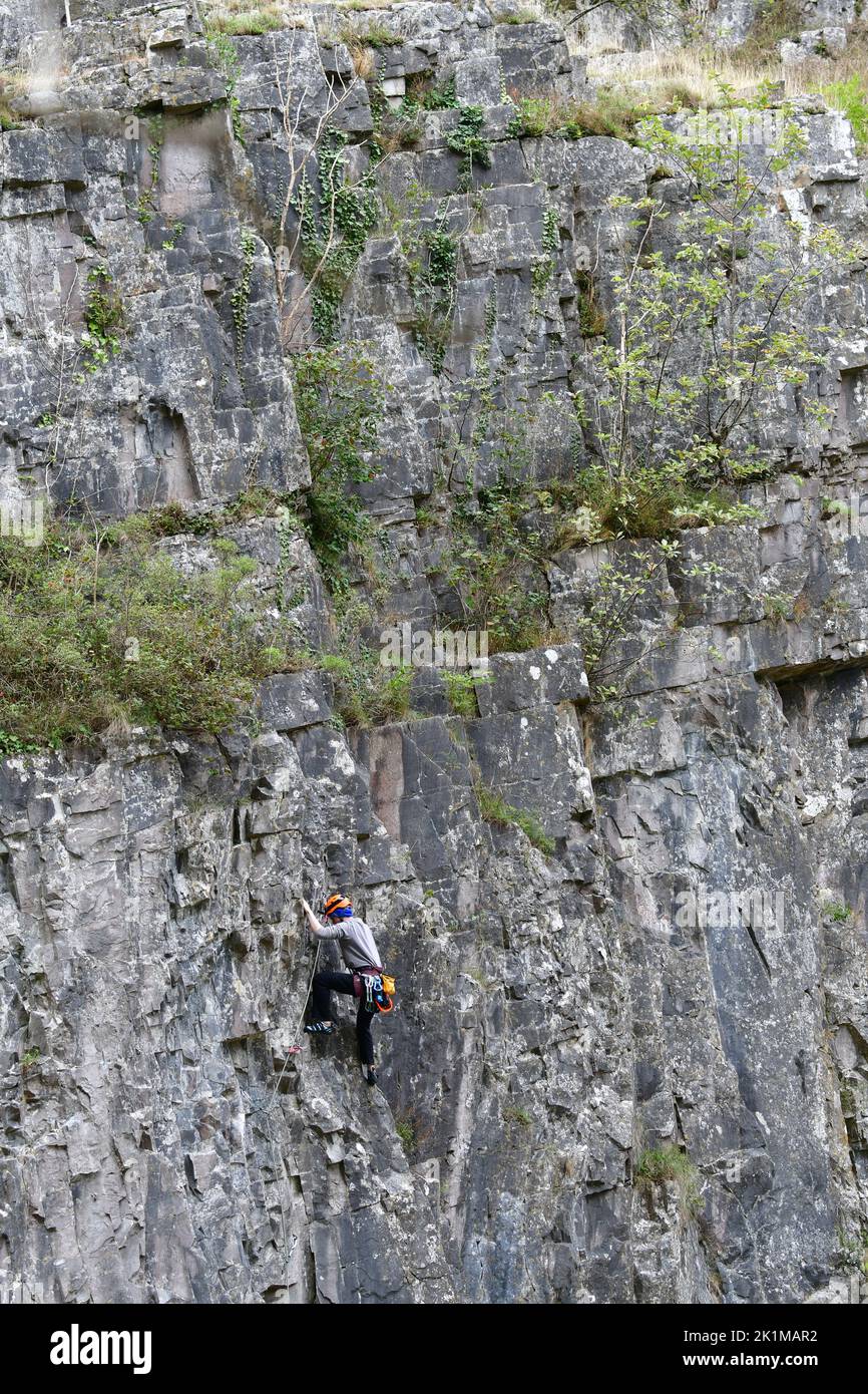 Cheddar, UK. 19th Sep, 2022. On a mild afternoon people climbing rockface of Cheddar Gorge with climbing safety ropes, helmet, shoes, and one climber with camera. Picture Credit: Robert Timoney/Alamy Live News Stock Photo