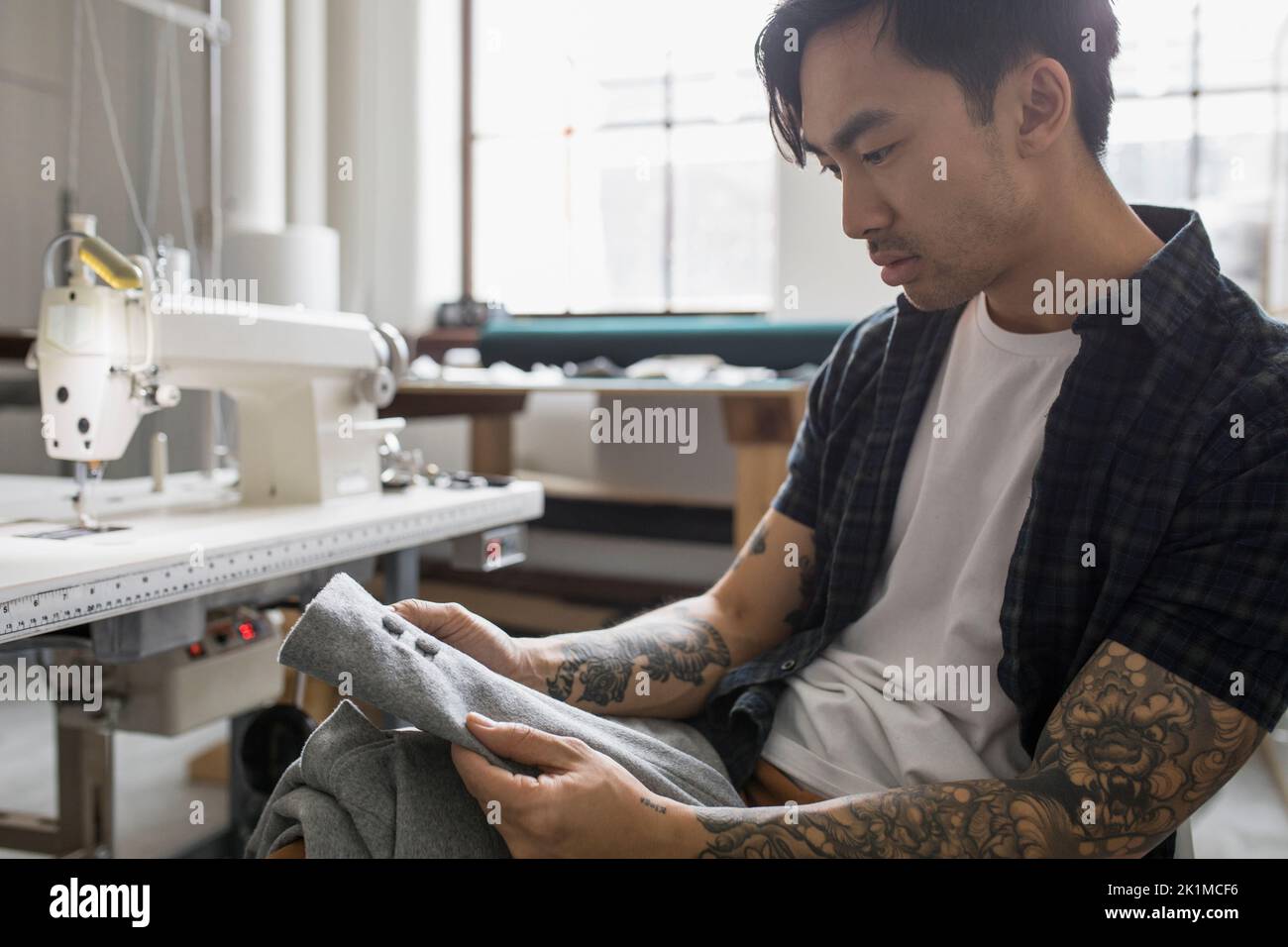Man holding jacket in fabric repair Stock Photo Alamy