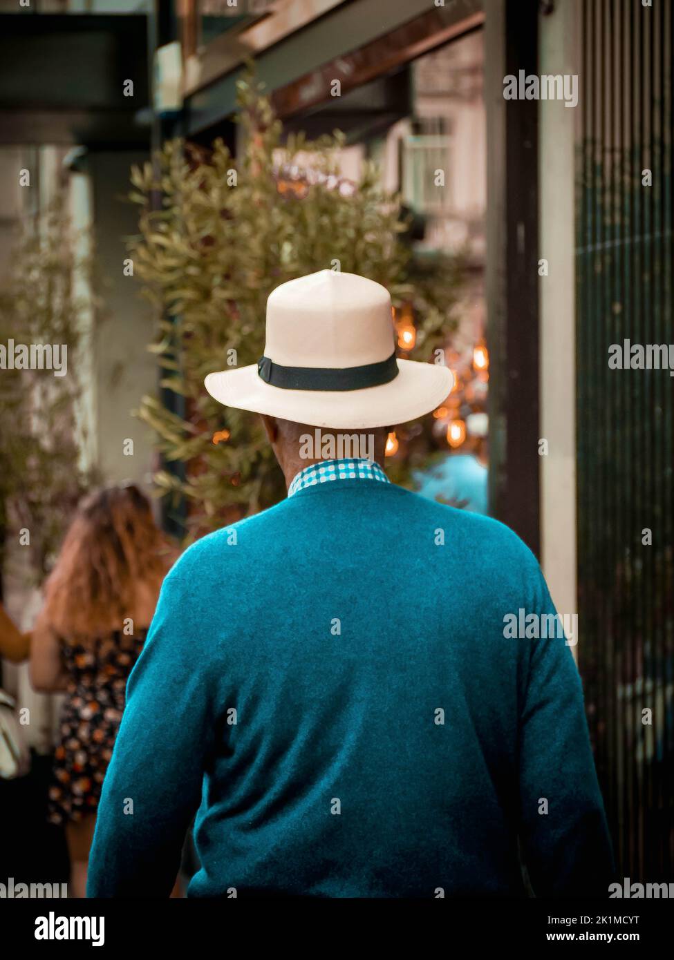 Elegant man in a hat walking on the street Stock Photo - Alamy
