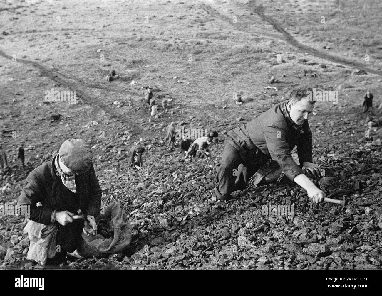 1930s, historical, unemployed ex-mineworkrs on a slag heap, South Wales. Stock Photo