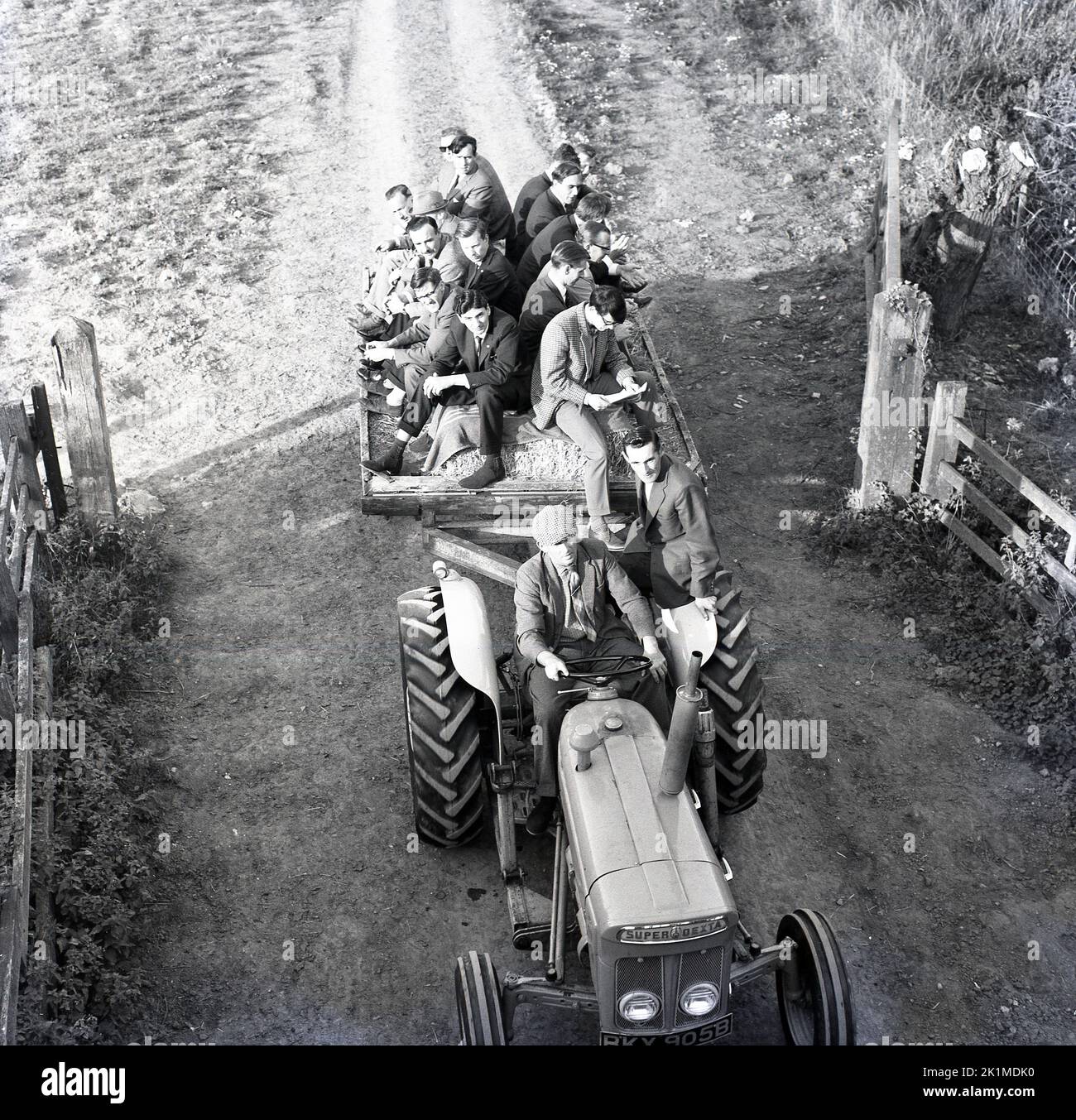 1964, historical, men on trailer on the back of a tractor, farm visit, tractor is a Super Dexta, numberplate RKY 905B Stock Photo