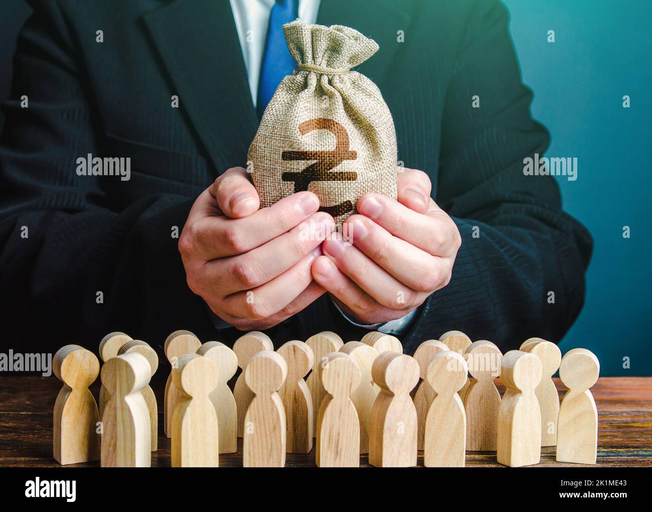 Businessman holds out a ukrainian hryvnia money bag to the crowd. Financial support for Ukraine. Staff maintenance. Tax collection. Compensation payme Stock Photo