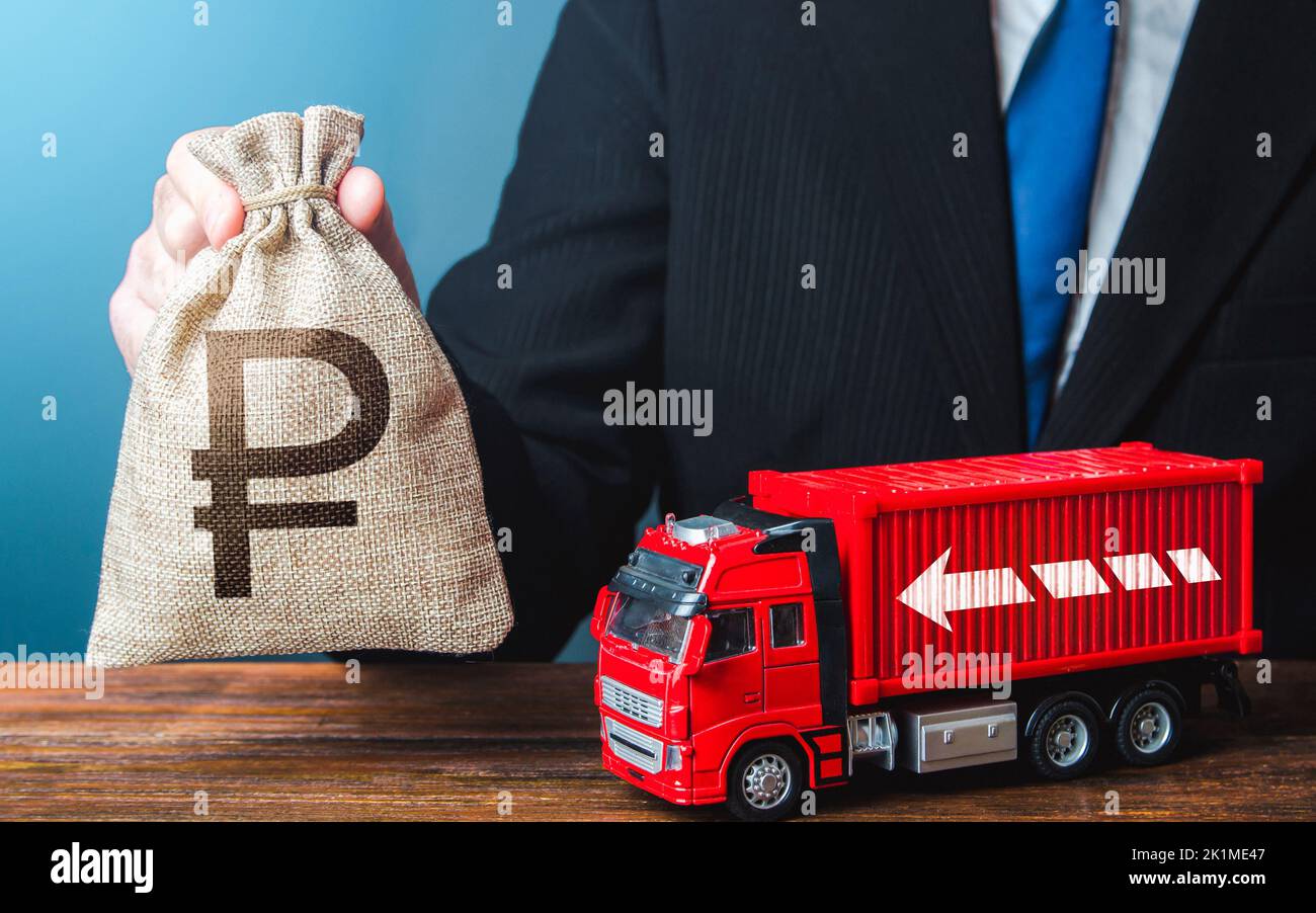 Businessman with russian ruble money bag and truck. Good salaries for drivers. High income of the transport business and the transport of goods. Risin Stock Photo
