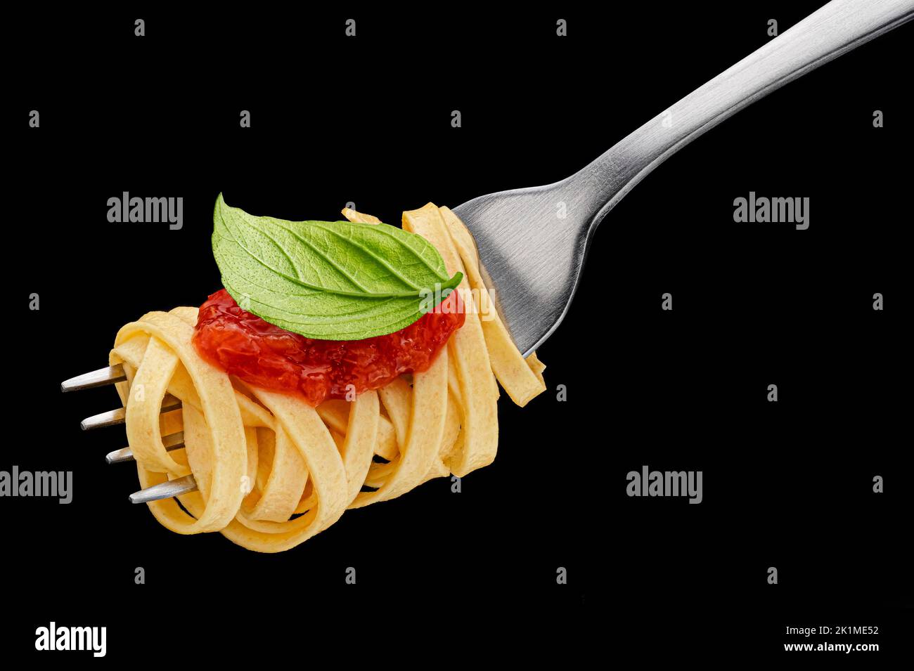 Italian spaghetti on fork on black background Stock Photo