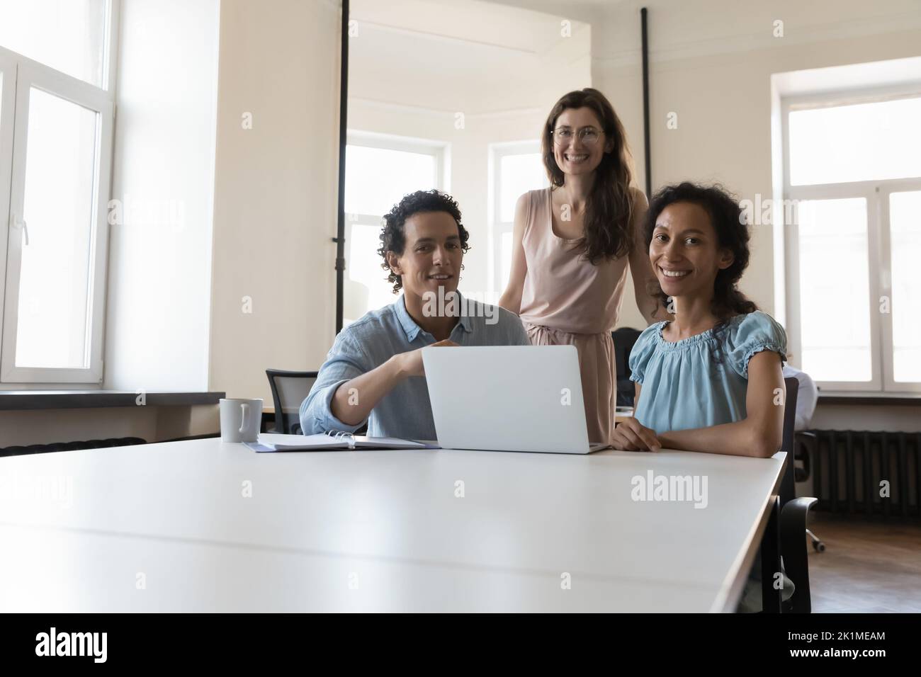 Happy successful business team posing at shared workplace Stock Photo