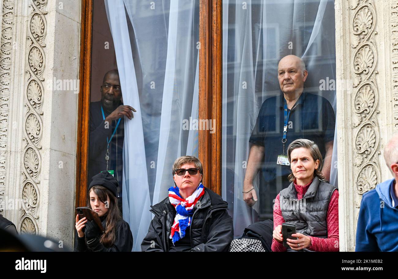 London, UK. 19th Sep, 2022. London UK 19th September 2022 - Whitehall staff take a peek through their windows during the funeral  of Queen Elizabeth II in London today: Credit Simon Dack / Alamy Live News Credit: Simon Dack News/Alamy Live News Stock Photo