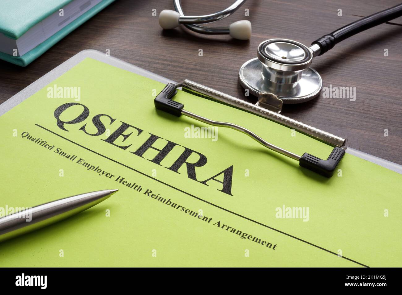 Papers about QSEHRA qualified small employer health reimbursement arrangement. Stock Photo
