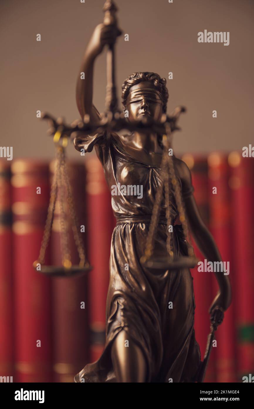 Zambian Crowd - LADY JUSTICE - DEPICTION Lady Justice, a blindfolded woman  carrying a sword and a set of scales, is a common symbol on courthouses.  She symbolizes fair and equal administration