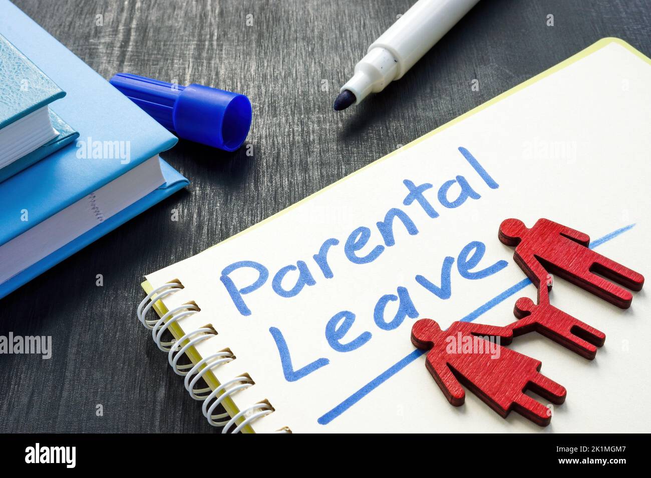 Handwritten parental leave and a family figurine. Stock Photo
