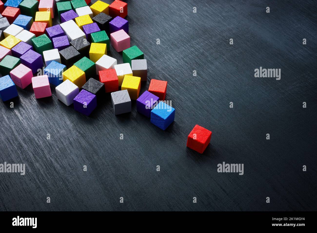 Multi-colored cubes as a symbol of the crowd and in front of one as leader. Stock Photo