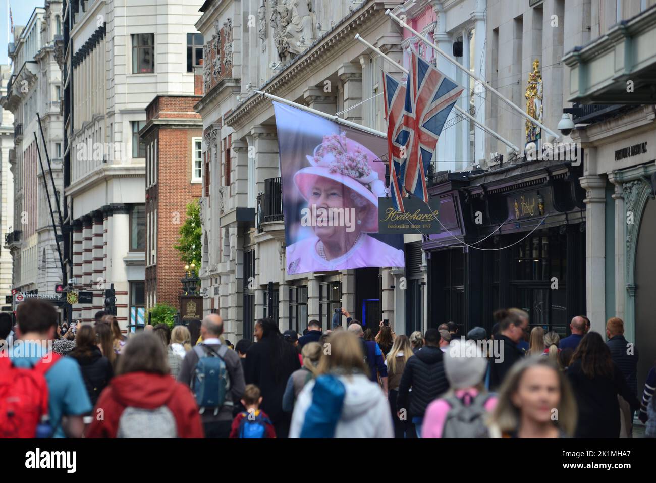 State funeral of Her Majesty Queen Elizabeth II, London, UK, Monday 19th September 2022. Picture tribute of Her Majesty the Queen and Union Jacks hanging outside a business on Piccadilly. Stock Photo