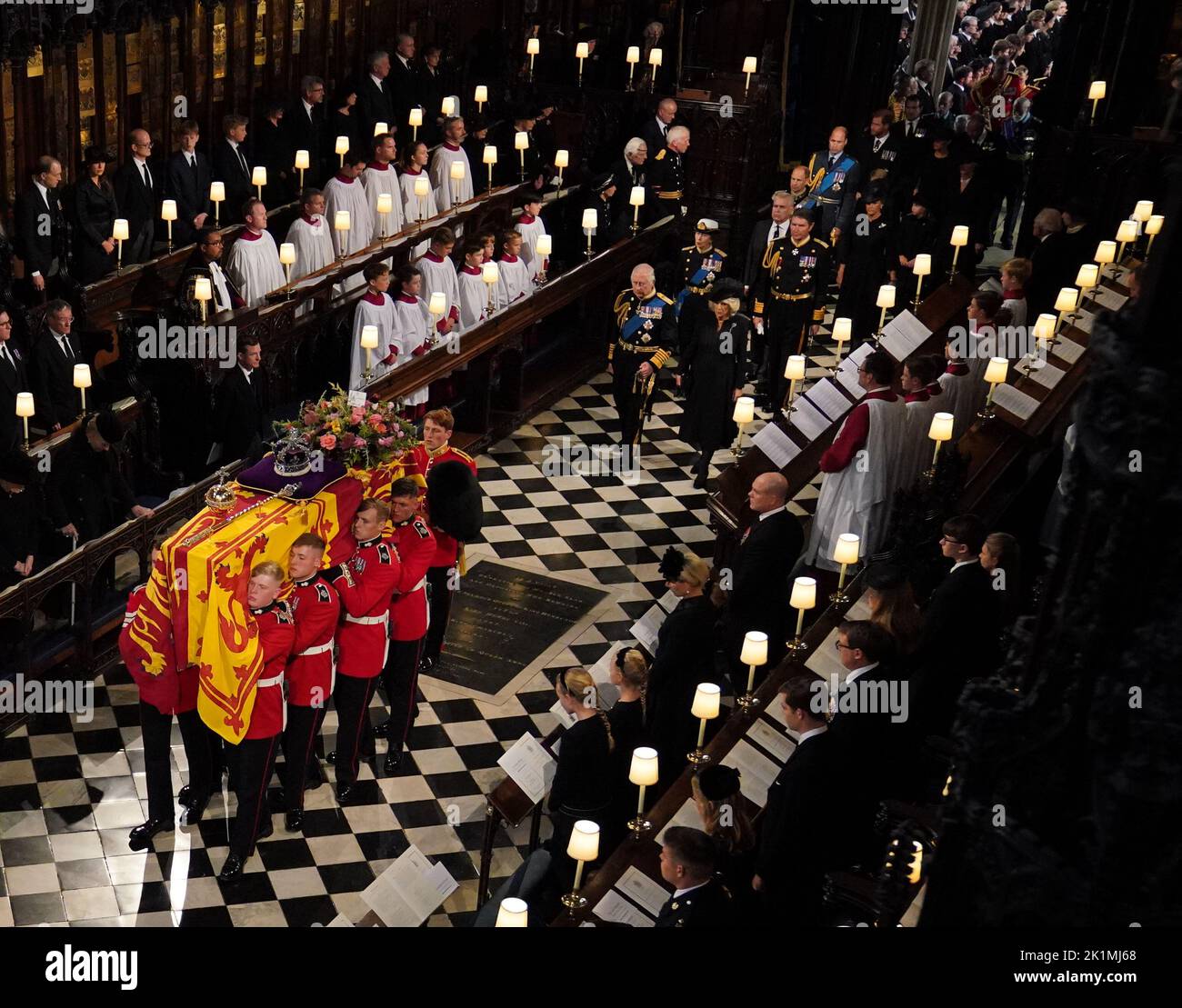 The coffin of Queen Elizabeth II, followed by (left to right, from front) King Charles III, the Queen Consort, the Princess Royal, Vice Admiral Sir Tim Laurence, the Duke of York, the Earl of Wessex, the Countess of Wessex, the Prince of Wales, Prince George, Princess Charlotte, the Princess of Wales, the Duke of Sussex, the Duchess of Sussex, Peter Phillips, the Earl of Snowdon, the Duke of Gloucester, the Duke of Kent, and Prince Michael of Kent, is carried by the Bearer Party in to the Committal Service at St George's Chapel in Windsor Castle, Berkshire. Picture date: Monday September 19, 2 Stock Photo