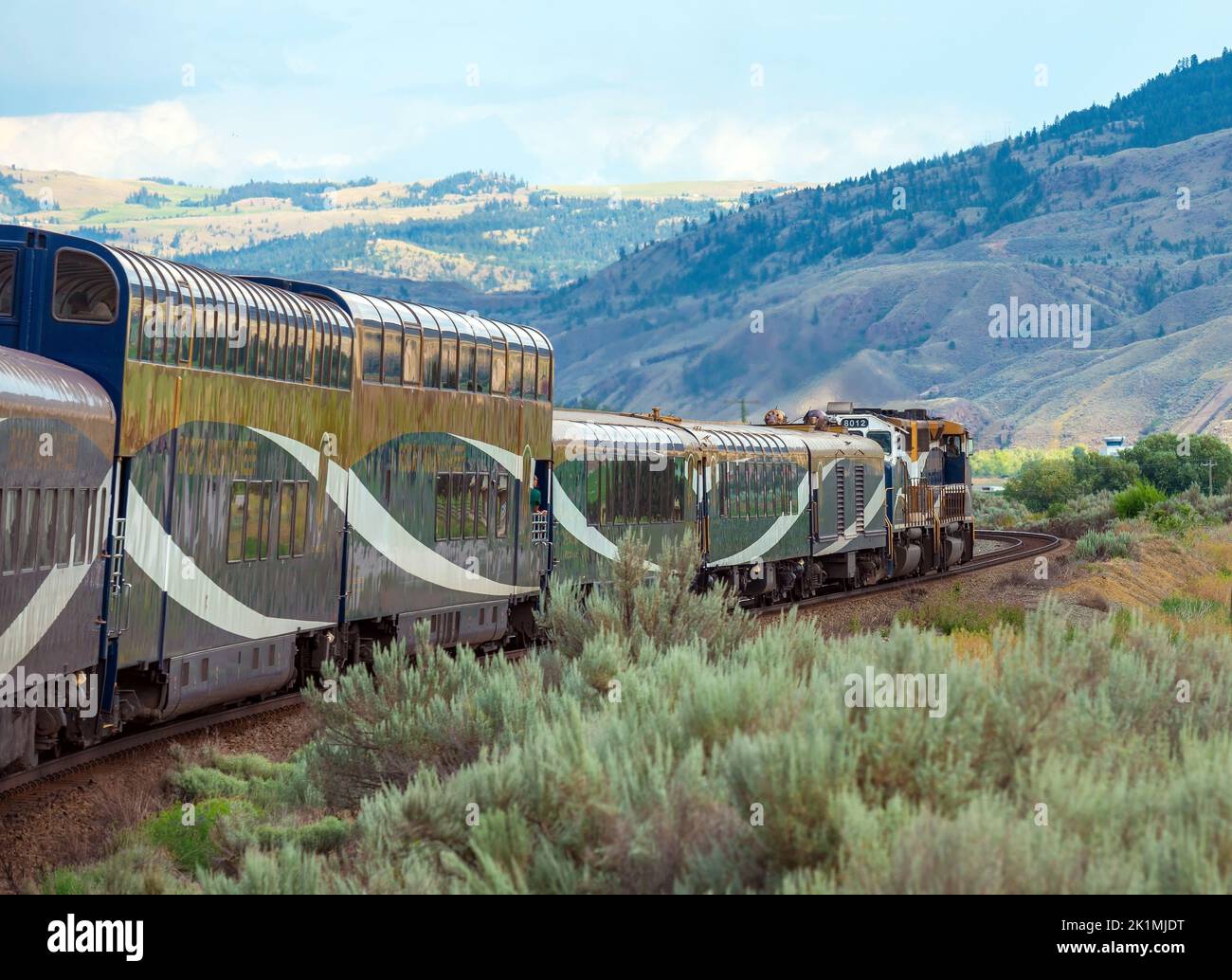Rocky mountaineer locomotive with gold and silver leaf train wagons near Kamloops, British Columbia, Canada. Stock Photo