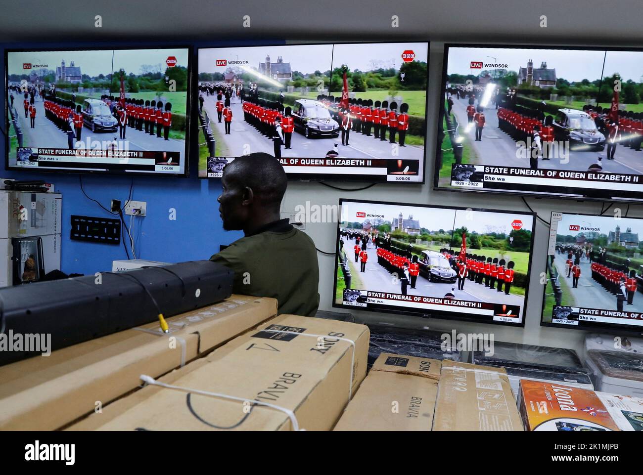 A television salesman watches the live screening of Britain's Queen Elizabeth State Funeral, in downtown Nairobi, Kenya September 19, 2022. REUTERS/Thomas Mukoya Stock Photo