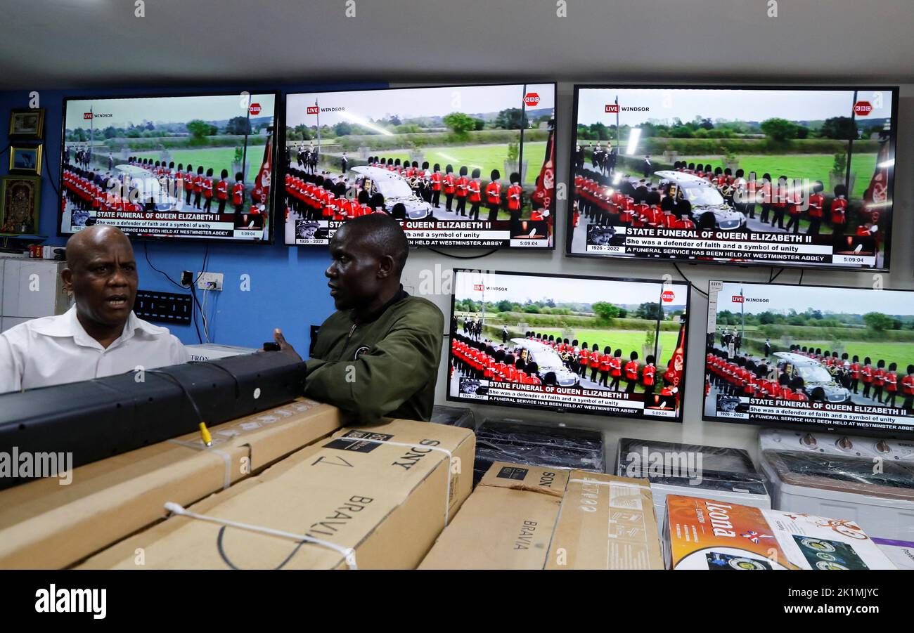 Salesmen wait for clients at a television store during the live screening of Britain's Queen Elizabeth State Funeral, in downtown Nairobi, Kenya September 19, 2022. REUTERS/Thomas Mukoya Stock Photo