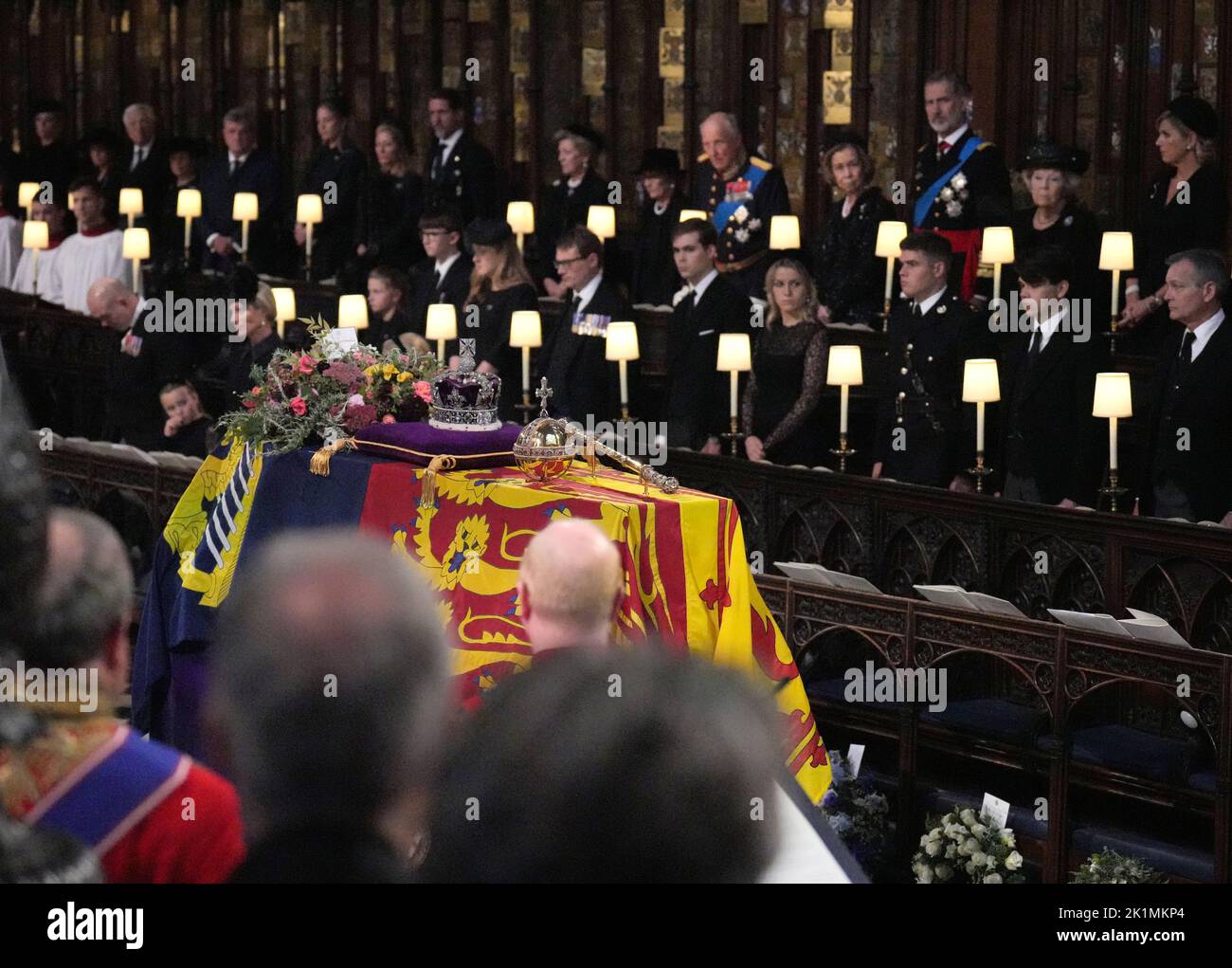 Members of the royal family stand for the coffin of Queen Elizabeth II, draped in the Royal Standard with the Imperial State Crown and the Sovereign's orb and sceptre, during the Committal Service at St George's Chapel in Windsor Castle, Berkshire. Picture date: Monday September 19, 2022. Stock Photo