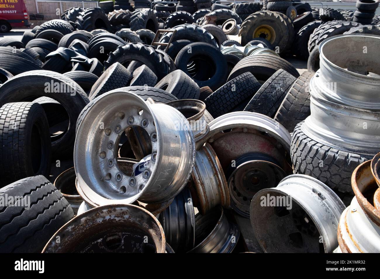 Pile of new and old car truck tractor vehicle tyres tires on a yard Llandovery Carmarthenshire Wales UK  KATHY DEWITT Stock Photo