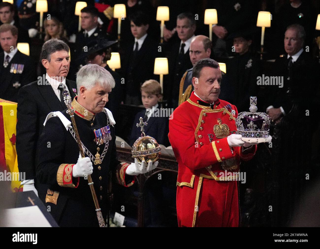 The Imperal State Crown, orb and sceptre are carried to the Dean of Windsor (not seen) to be placed on the high altar during the Committal Service for Queen Elizabeth, at St George's Chapel in Windsor Castle, Berkshire. Picture date: Monday September 19, 2022. Stock Photo
