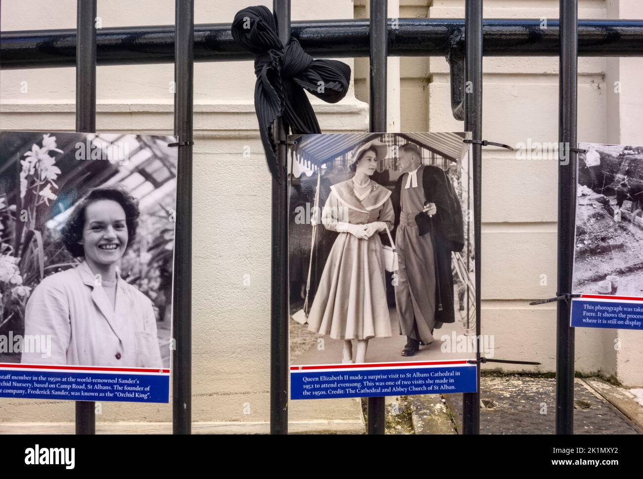Black and White pictures of Queen Elizabeth II attached to the railings, Market Place, St. Albans, Hertfordshire as a tribute Stock Photo