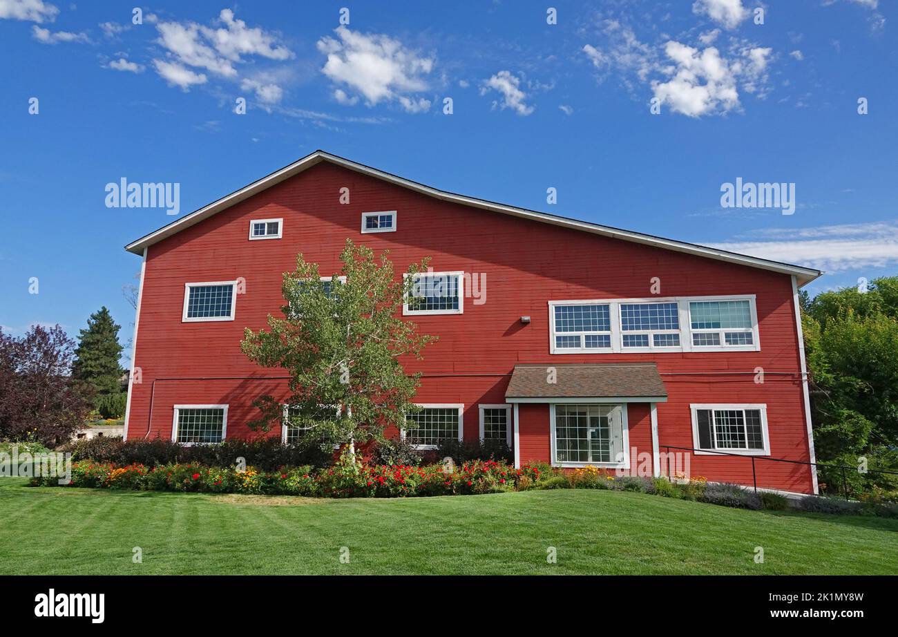 A red office building along the Deschutes Riever in the town of Bend, Oregon. Stock Photo