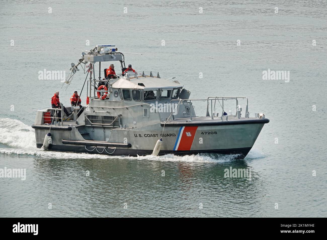 A US Coast Guard 47 foot motor llifeboat cruises down the harbor near Florence, Oregon Stock Photo
