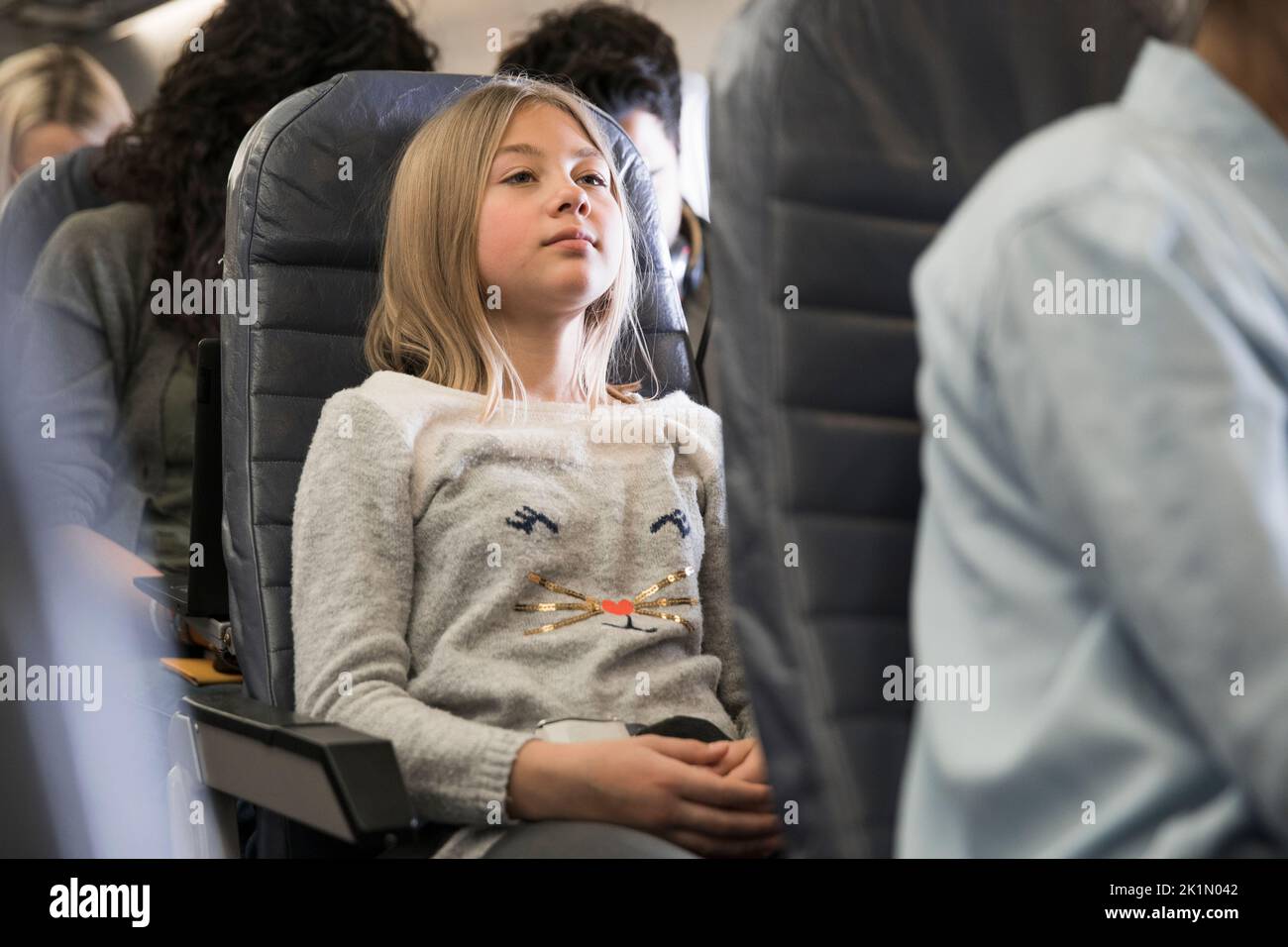 Preteen girl riding in airplane Stock Photo