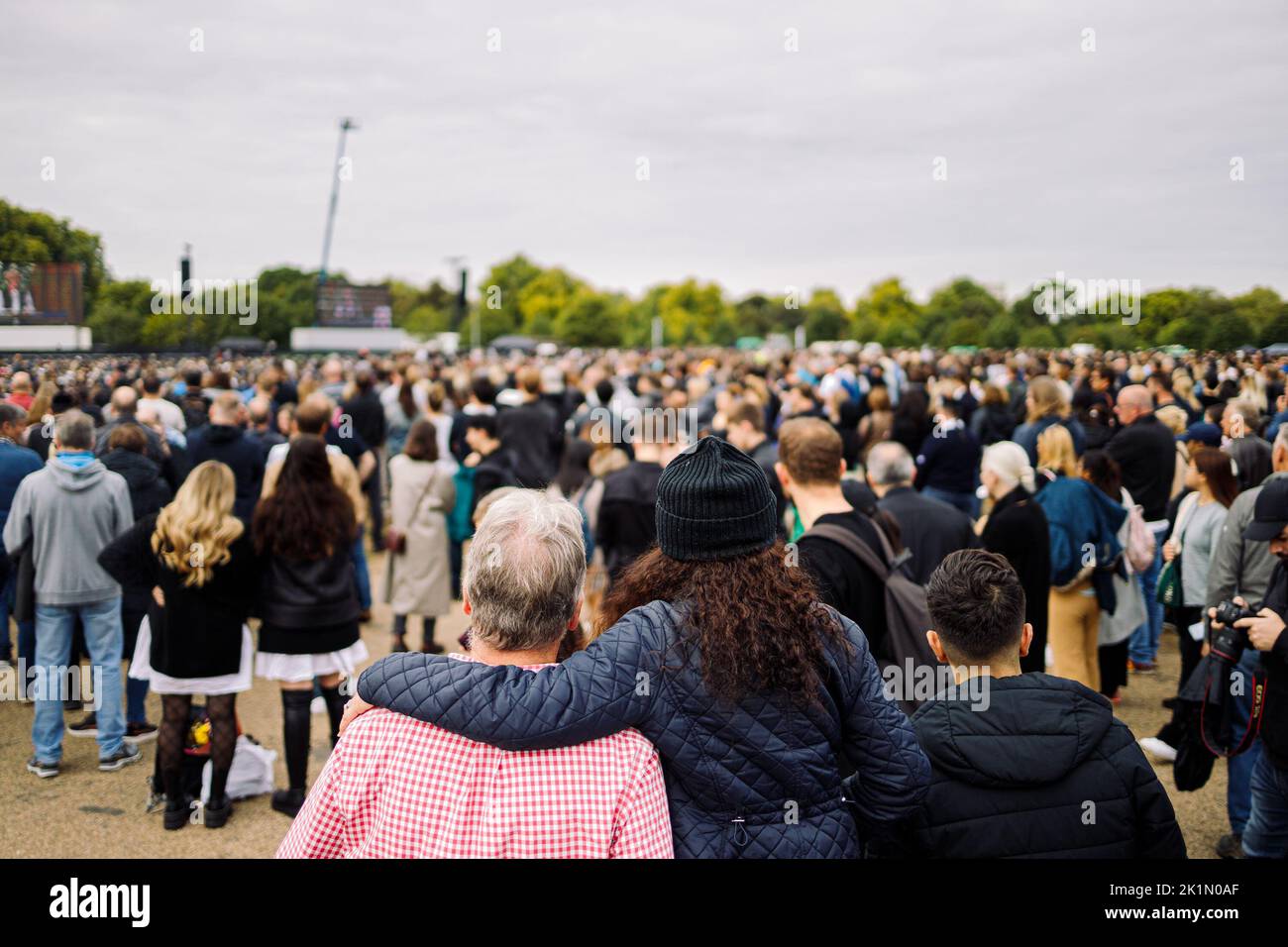 London, UK. 19th Sep, 2022.   Two people embracing in Hyde Park as they watch the funeral of Queen Elizabeth II from the big screens Credit: Massimiliano Donati/Alamy Live News Stock Photo