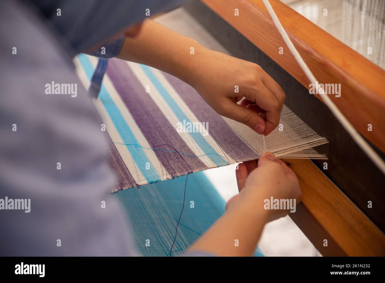 Carpet weaving using traditional techniques on a loom. , closeup of