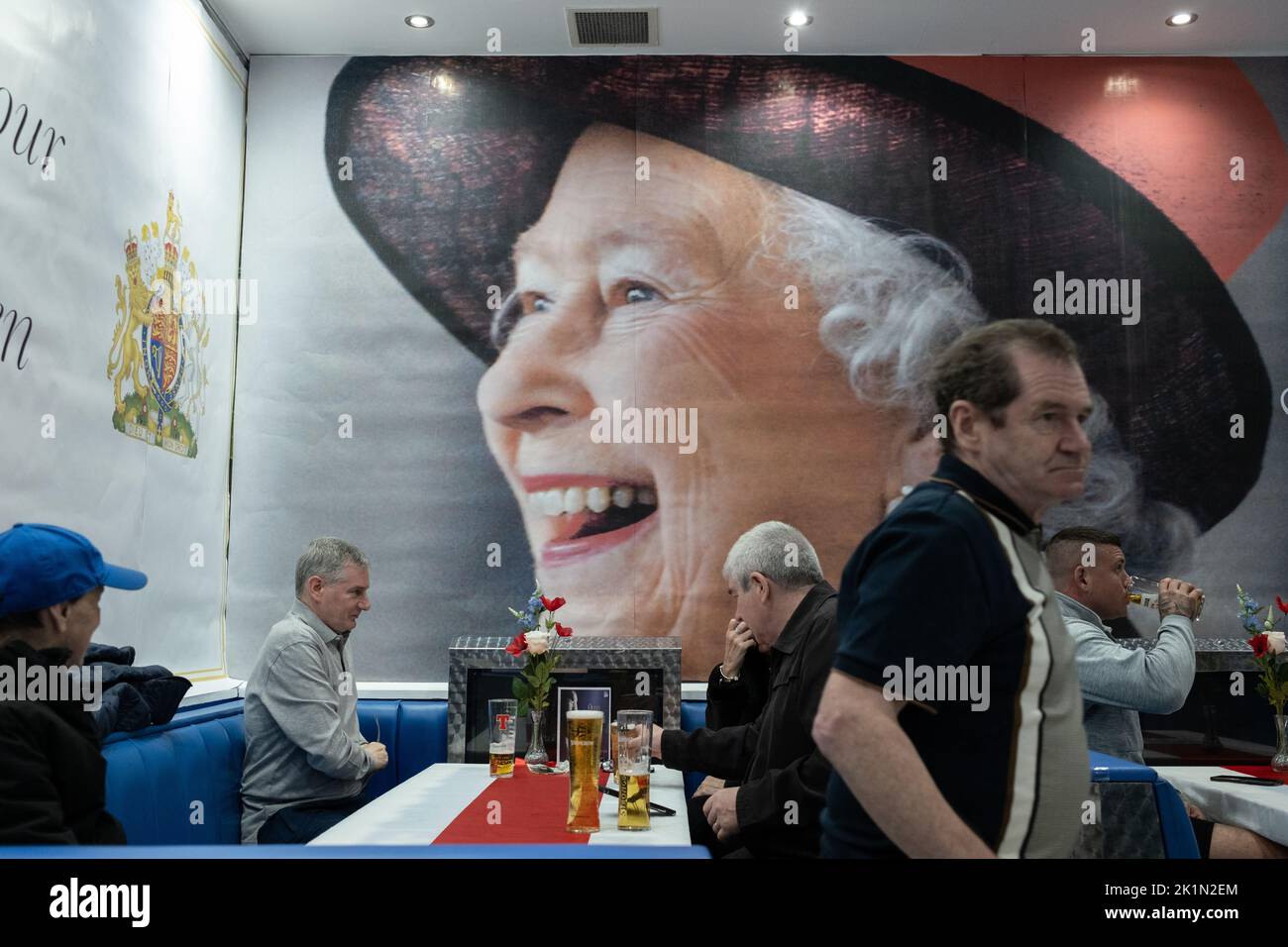 Glasgow, Scotland, 19 September 2022. Glaswegians drink in the Rangers FC supporters’ Bristol Bar, which for two days has called itself the Queen Elizabeth Arms, while watching the funeral of Her Majesty Queen Elizabeth II who died on 8th September, in Glasgow, Scotland, 19 September 2022. Photo credit: Jeremy Sutton-Hibbert/Alamy Live News. Stock Photo